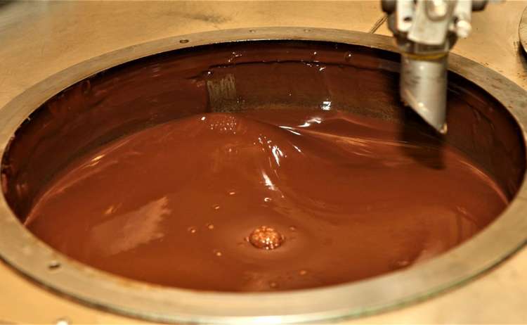 In großen Tanks wird die Schokolade gelagert, in wenigen Sekunden wird das flüssige Gut in die Eierformen gespritzt.